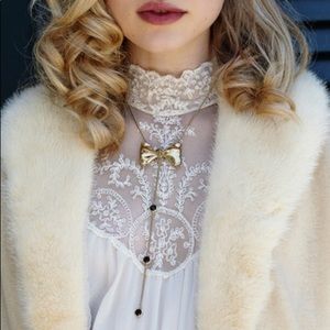 Mr. Kate “Le Cadeau” lariat necklace.